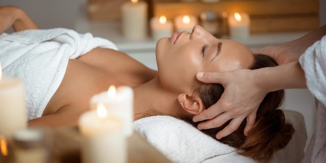 young-woman-having-face-massage-relaxing-spa-salon-min